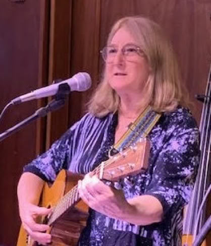 Close-up view of a drum with drumsticks placed on it, highlighting musical performance.